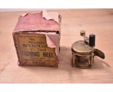 A vintage Pflueger brass 40yd raised pillar multiplying fishing reel in original box fully working measures 1.5 inches