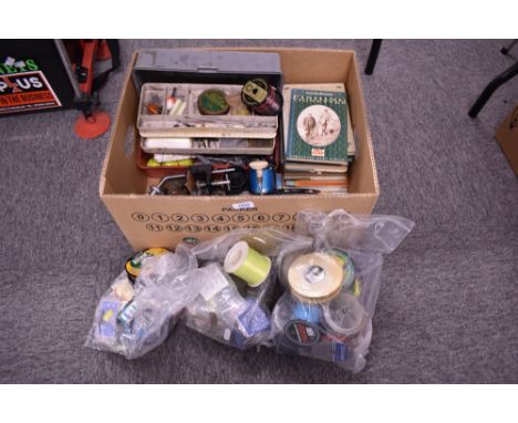 A box of assorted tackle including vintage reels, line, weights, lures and books