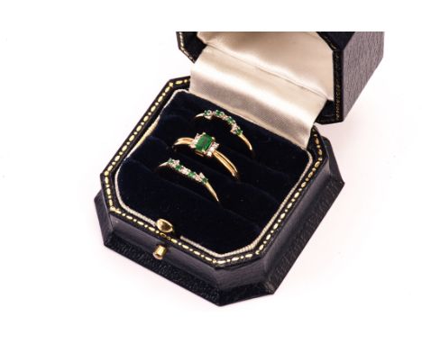 A set of three 9ct gold emerald and diamond rings from Brooks & Bentley, the middle ring with baguette cut green stone and th