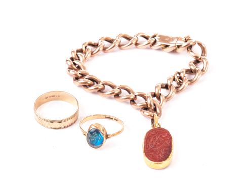 A curb link bracelet with carved carnelian charm, the 9ct gold bracelet supporting an oval carnelian pendant with Islamic scr