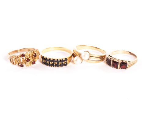 A group of four 9ct gold and yellow metal dress rings, one 1970s example with garnets, one crossover style with two pearls, o