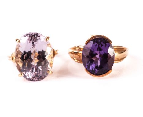 Two gold and large single stone dress rings, one in 18ct with light pink oval stone, the other in 9ct gold with oval purple s