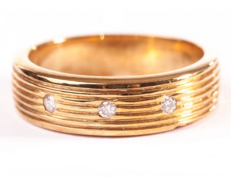 A 9ct gold and diamond gentleman’s signet ring or wedding band, having engraved lines to tablet set with three brilliant cuts