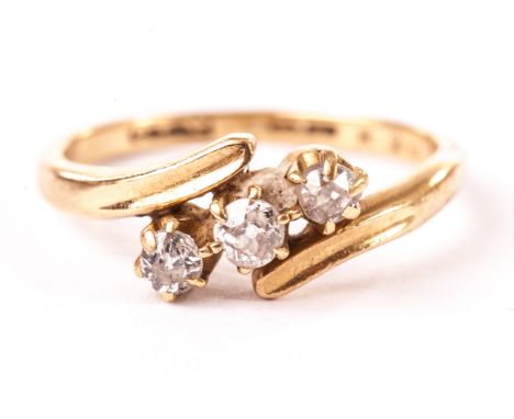 A three stone diamond ring, having three old cut stones in crossover style mount, marked worn 