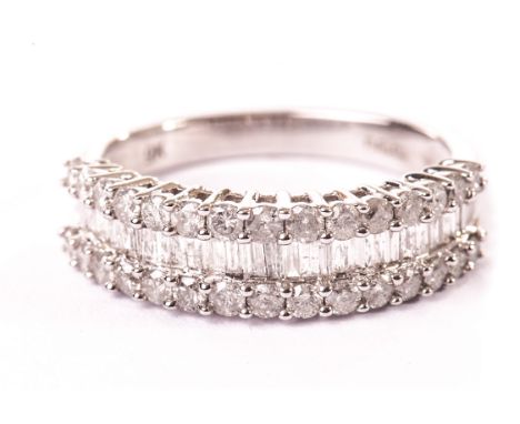 A 9ct gold and diamond half hoop eternity ring, having two rows of small brilliant cuts and a central row of baguette cuts in