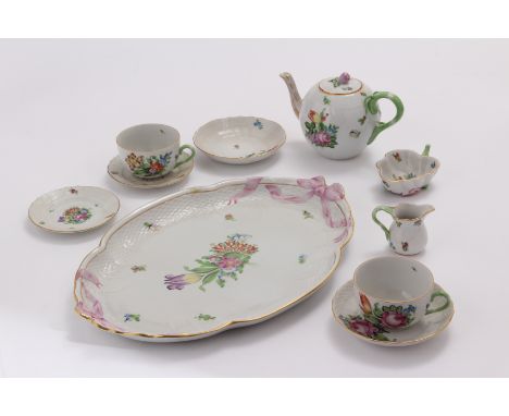 A Herrend porcelain tete-a-tete tea set, comprising tea tray, teapot, sugar basin, jug, four saucers and two cups, one AF (11