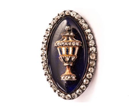 An eighteenth century enamel and diamond mourning brooch, navette shaped and set with a white enamel, diamond, and sapphire e