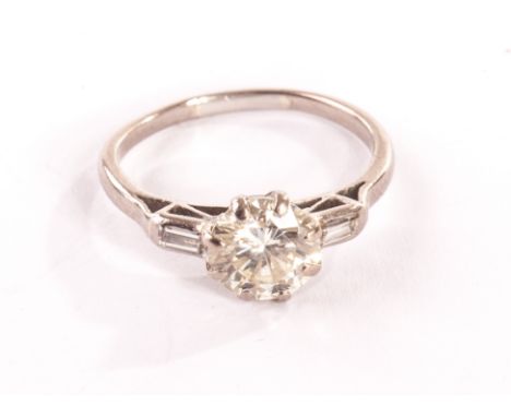 A vintage diamond solitaire engagement ring, the brilliant cut of approx 1.3ct in eight claw setting having a baguette cut to