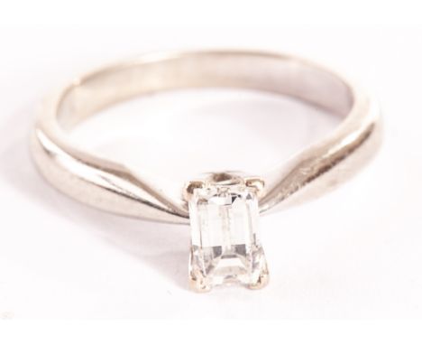 A modern diamond solitaire engagement ring, the baguette cut style stone with faceted top, approx 0.7ct, in four claw in 18ct