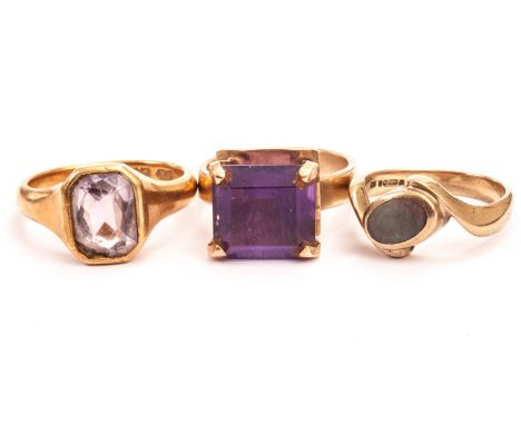 Three gem set dress rings, including an 18ct gold and amethyst signet ring, a 9ct gold and amethyst 1970s ring and a yellow m