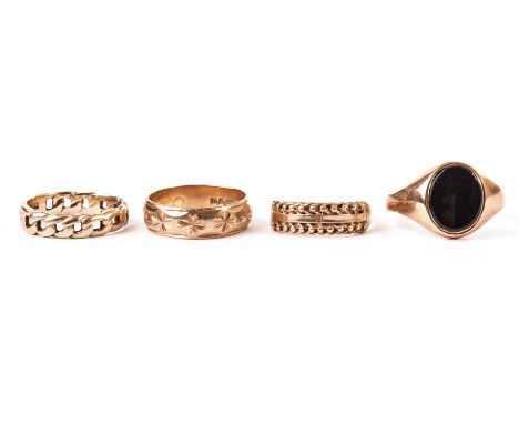 A group of four 9ct gold rings, including one gent’s signet ring with onyx tablet, a textured wedding band and two others (4)