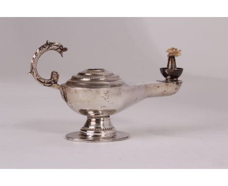 A Middle Eastern white metal table lamp, modelled as a Roman style lamp with mythical beast handle, bearing strike marks, pos