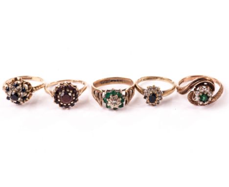 A group of four 9ct gold and gem set cluster style rings, together with another gem set ring, including one with garnets, two