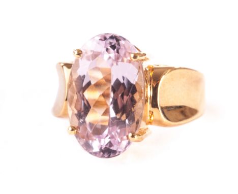 An 18ct gold and large single stone dress ring, the oval cut pink stone in four claw setting in mount with wide concave shoul