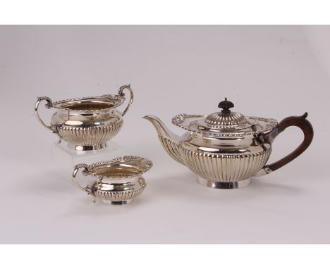 A Victorian silver three piece tea set by Goldsmiths & Silversmiths, retailed through William Gibson & John Langman, the squa