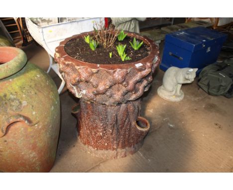 A large garden planter in the form of a tree trunk