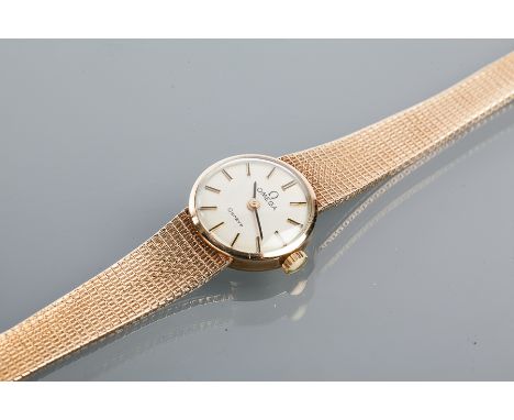 LADY'S NINE CARAT GOLD OMEGA WRISTWATCH WITH GOLD BRACELET STRAP
the silvered dial with baton hour markers, in nine carat gol