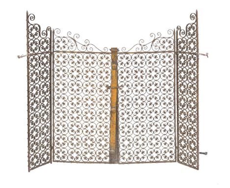 A pair of Continental wrought iron gates and bearer panels, 19th century, each with openwork scrolling throughout rising to m