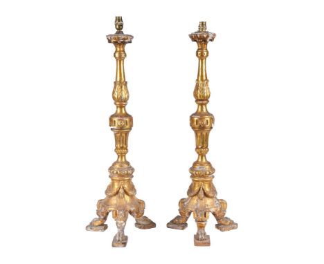 A pair of Italian giltwood pricket altarsticks refitted as table lamps, 19th century and later adapted, each baluster and mul