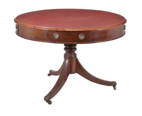 A mahogany drum table, circa 1820 and later, the red inset top above the arrangement of drawers, turned pillar and three outs