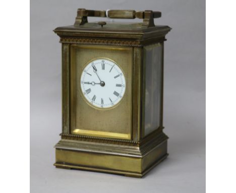A French silvered brass carriage clock, having hour-repeat movement with circular enamelled Roman dial and engine-turned mask