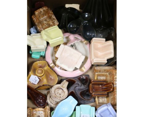 A collection of twenty nine ceramic pipe rests, including several modelled as armchairs, settees, etc.