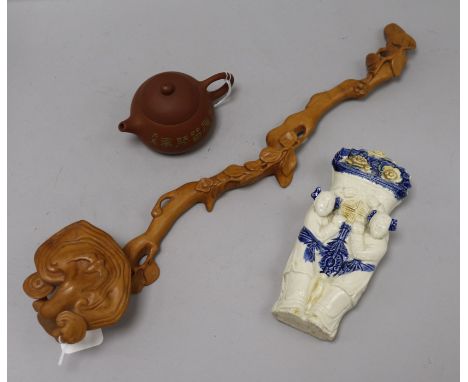 A Chinese wood ruyi sceptre, a Yixing teapot and a ceramic wall pocket ruyi sceptre length 47cm