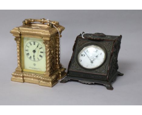 A gold-plated pocket watch in cast brass enclosed watch stand and an Ansonia Clock Co. gilt metal carriage clock, the keyless