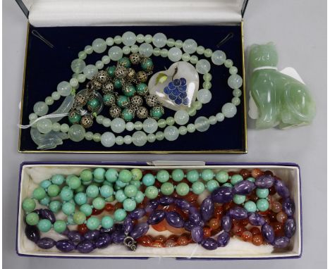 A collection of hardstone bead necklaces, including a pale green jade example with dragon clasp, an agate example with carved