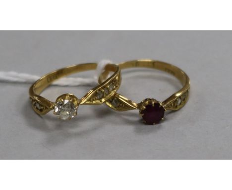 An 18ct gold and single stone diamond ring with diamond set shoulders and an en suite ruby and diamond ring, size K.