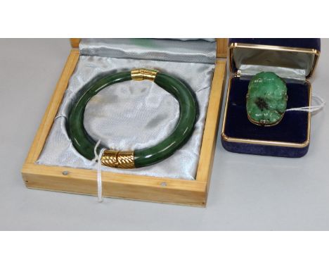 A modern jade and yellow metal-mounted bangle (unmarked) and a similar tablet ring, mounted with a carved and pierced design 