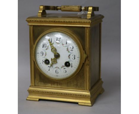 A French gilt brass carriage clock, striking on gong and having circular enamelled Arabic dial decorated with swags, in archi