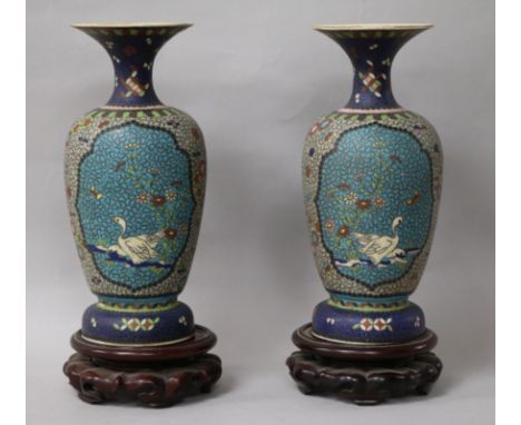 A pair of Japanese ceramic cloisonne vases, on stands height 22cm
