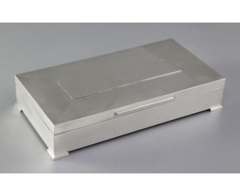 A 1960's engine turned silver rectangular cigarette box, on bracket feet, Padgett & Braham Ltd, London, 1966, 24.8cm.