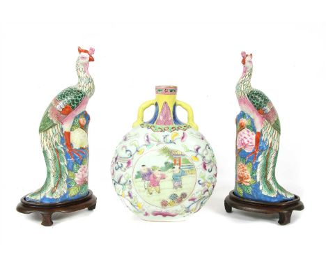 A pair of Chinese famille rose figures, of peacocks standing on a rock above peony, 31cm high, wood stands, and a famille ros