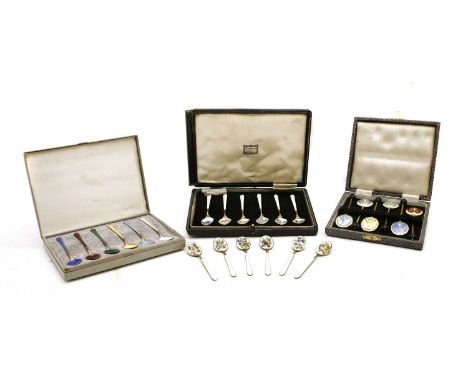 A set of twelve silver gilt and enamel coffee spoons , decorated with engine turning and floral spray to the bowls, together 