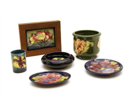 A collection of Moorcroft items, to include a signed plaque, a trinket jar and a dish, a pin dish, another example and a plas