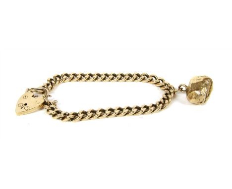 A 9ct gold curb bracelet, the links with engine turned decoration, to a heart shaped padlock clasp, Birmingham 1974, suspendi