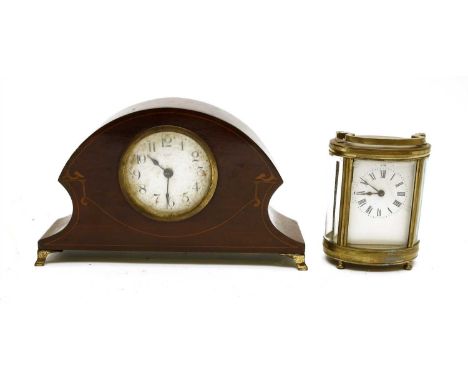 An Edwardian mahogany mantel clock, together with an oval brass cased carriage clock, having white enamel dial and black Roma