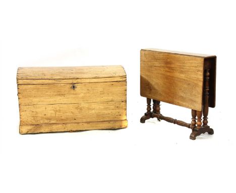An Edwardian walnut Sutherland table, 79cm wide, 16cm deep, 72cm high, together with a pine dome topped trunk, 95cm wide, 50c