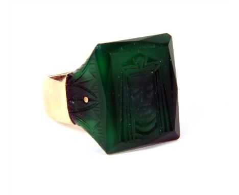 A 9ct gold dyed green agate ring, with carved dyed green agate head and shoulders, the head engraved with the head of a pharo