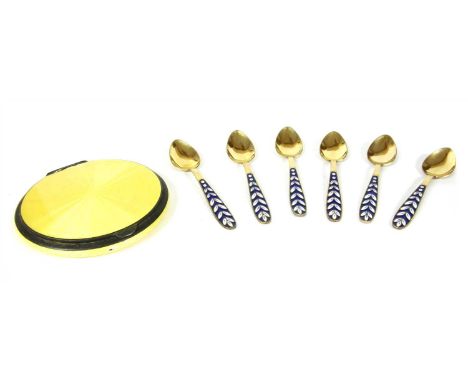 A German silver guilloché enamel compact, with a circular rose engine turned ground, with primrose yellow enamel, marked 935,