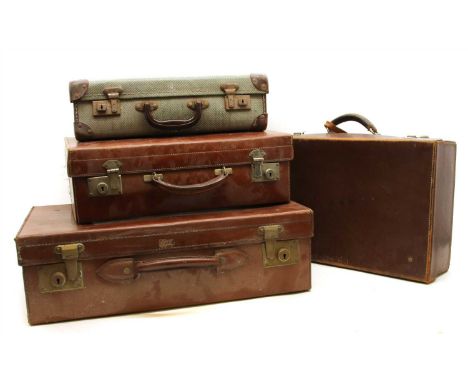 A selection of vintage leather and fabric suitcases