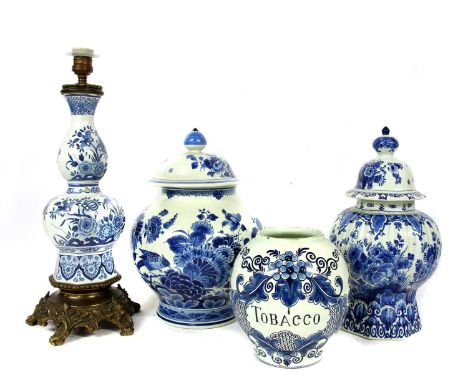 Four Delft pottery items, two lidded jars, a tobacco jar, and a gilt mounted lamp base, with modern shade, 51cm to top of col