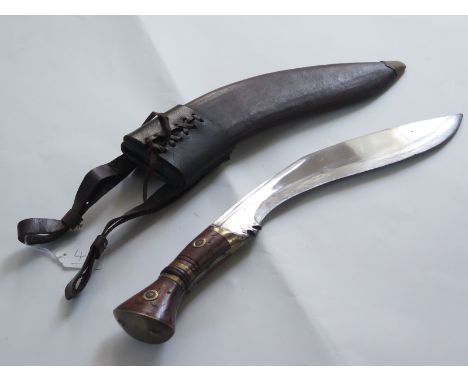 Kukri: A good copy of a WW1 Gurka Kukri. Blade 13" marked 'Co I G II 1917 & 37'. In its leather scabbard with laced frog. In 