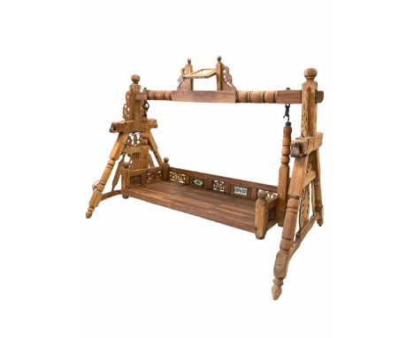 Indian hardwood swinging seat, inset with ceramic tiles, the 'A' frame end supports carved with Elephants and pierced floral 