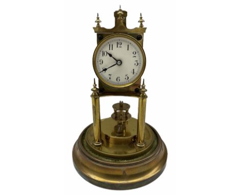 An early 20th century German torsion pendulum clock manufactured by Gustav Becker, with a cream enamel dial within a spun bra