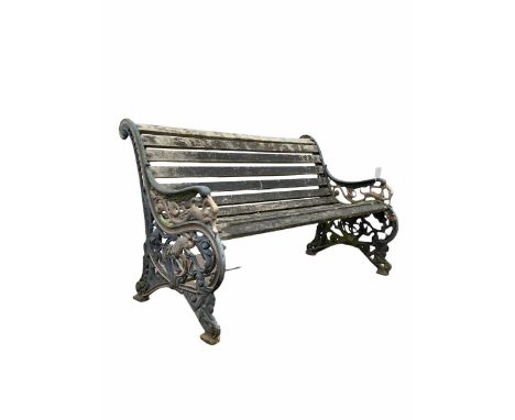 Early 20th century two seat bench, the black and gilt painted ends with leaf and mythical beast decoration, bearing the lette