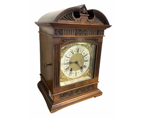 Late 19th century striking mantle clock in architectural walnut case, arched pediment with central leaf carved motif, enclose