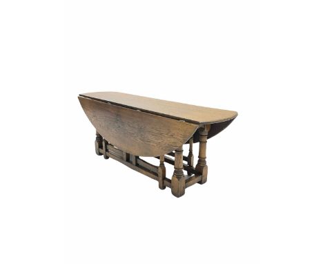 17th century style medium oak coffee table, the oval top with two drop leaves and four gate leg action, turned and block supp